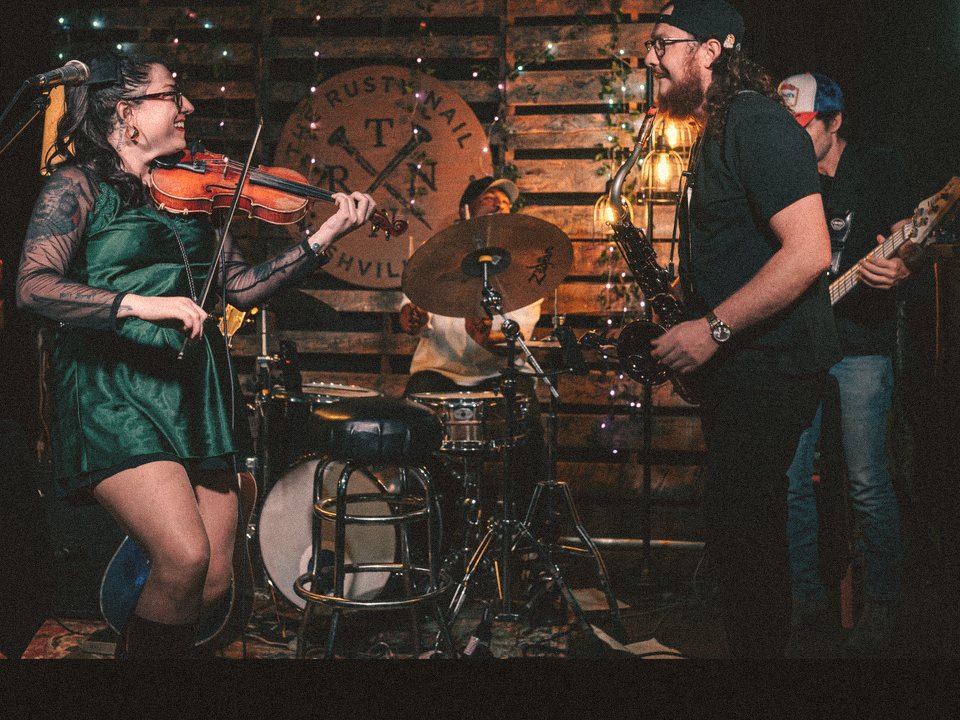 Tori on fiddle facing the sax player with Soul Theory